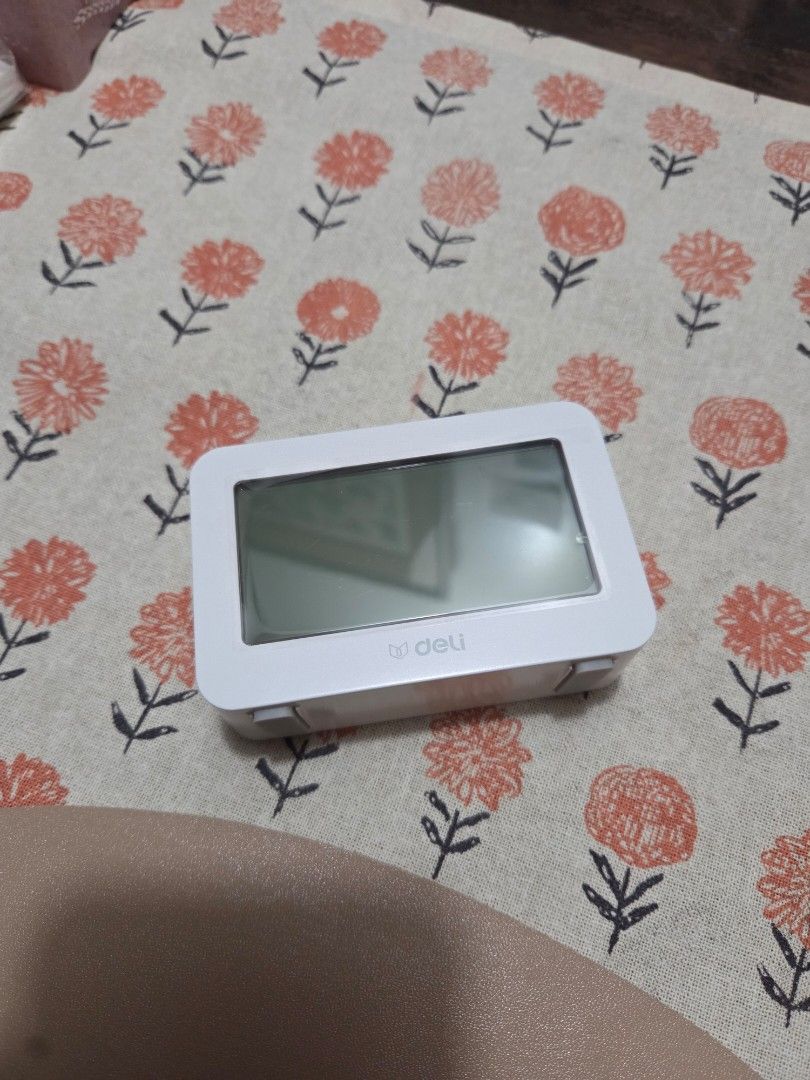 Deli Digital Alarm Clock (Category: Clocks) located in Makati City. Submitted by shoppreloved_ (Listing ID 1438433555, Image 2). Description: - Digital alarm clock by Deli - Originally bought for 600 - clock face still has the protective plastic - Displays time, date, temperature, and day of the week - Features a clear display with backlight - Set up to 3 different alarms - Modern and simple white design.