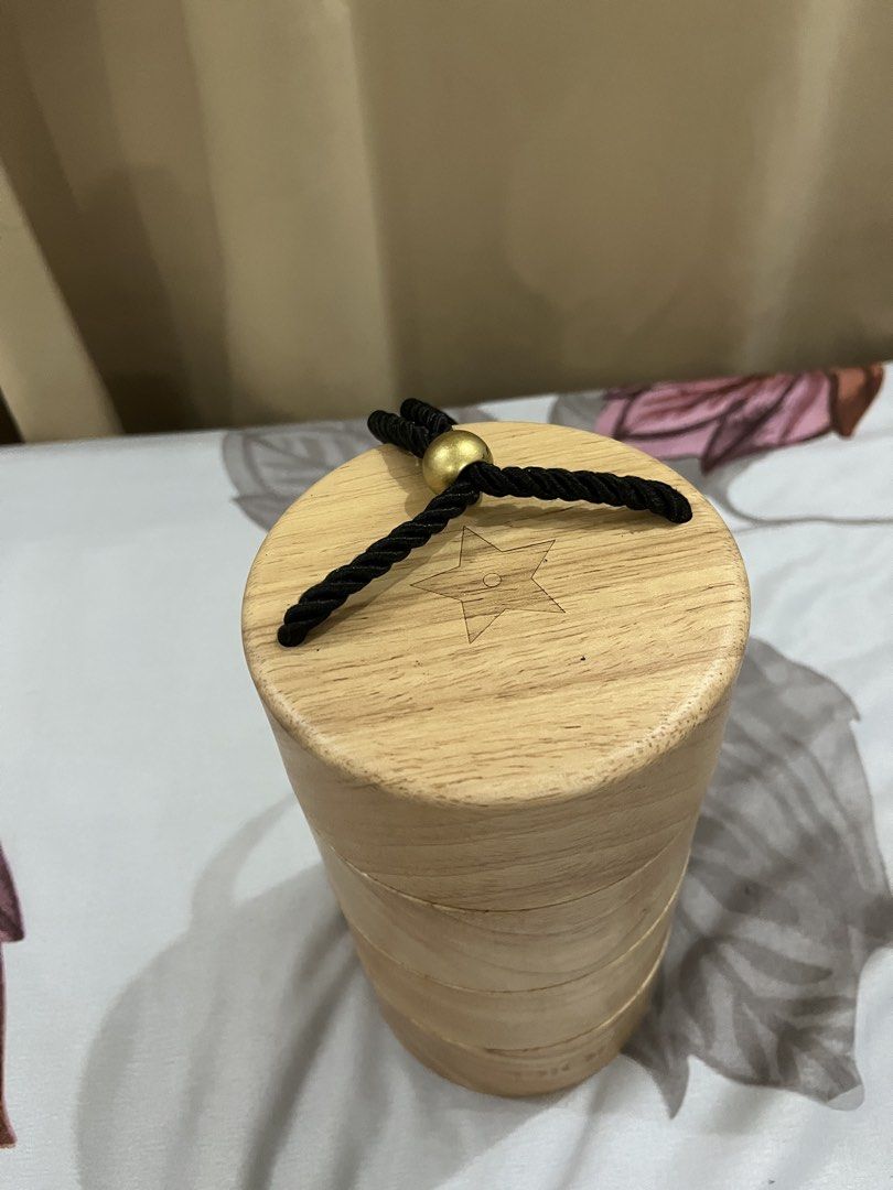 Dior Wooden Box- VIP gift (Category: Luxury Accessories) located in Manila. Submitted by princess.01.1 (Listing ID 1438429453, Image 2). Description: - Authentic Dior wooden box - Cylindrical shape with stacked sections - Dior logo at the bottom - Star design on top - Black rope closure with gold-colored bead.