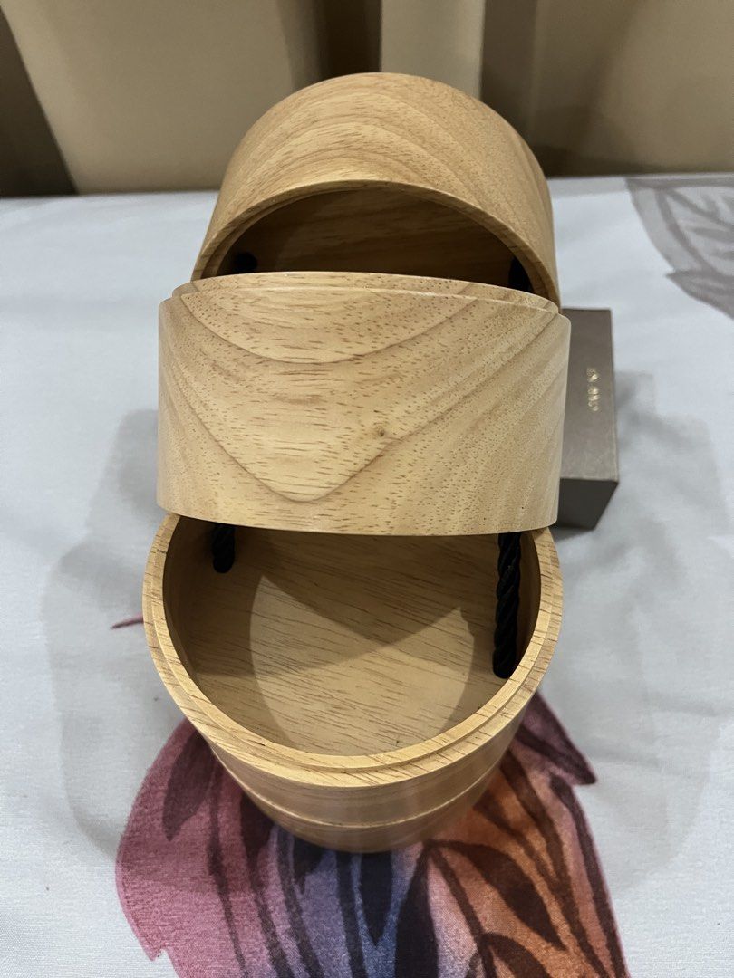 Dior Wooden Box- VIP gift (Category: Luxury Accessories) located in Manila. Submitted by princess.01.1 (Listing ID 1438429453, Image 3). Description: - Authentic Dior wooden box - Cylindrical shape with stacked sections - Dior logo at the bottom - Star design on top - Black rope closure with gold-colored bead.