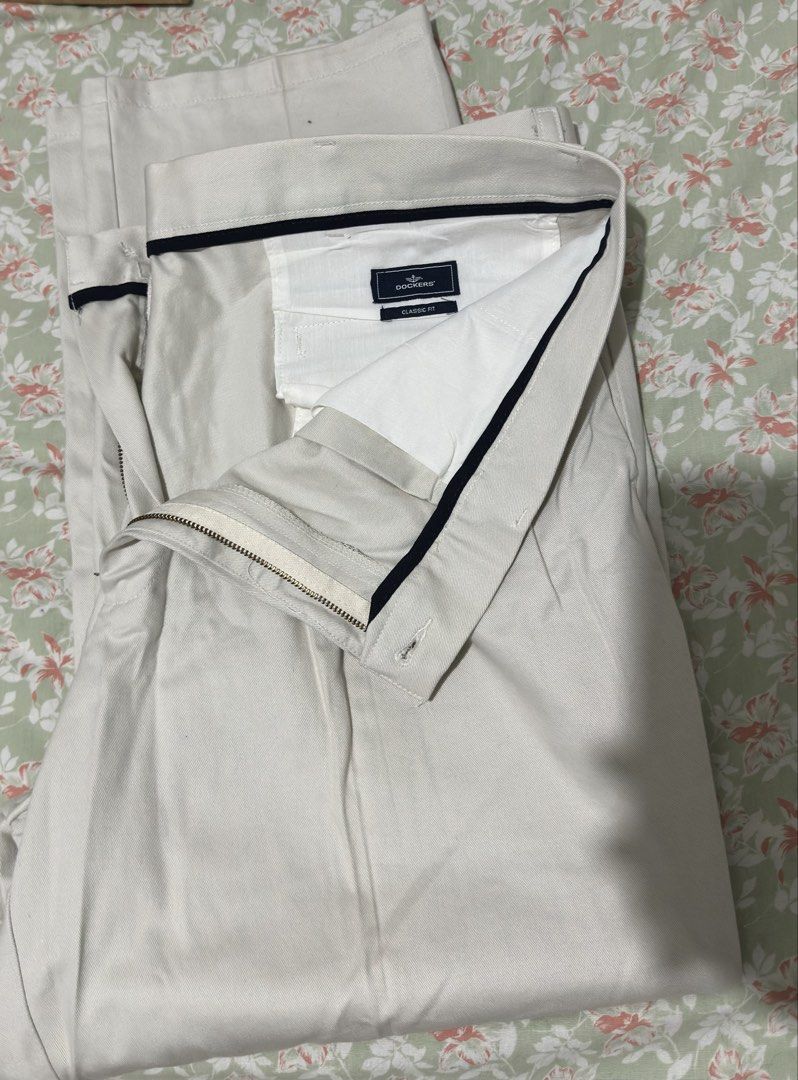 Dockers Classic Fit Pleated Pants (Category: Trousers) located in Paranaque City. Submitted by littlebitofeverythingph (Listing ID 1438441851, Image 1). Description: - Classic fit Dockers pants - W40 L29 - Beige color - Pleated design - Made in Kenya - Two front and two back pockets - Zipper and button closure - Tag reads: "Classic Fit" and "Pleated" .