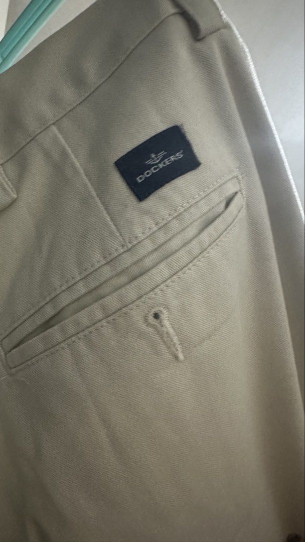 Dockers Classic Fit Pleated Pants (Category: Trousers) located in Paranaque City. Submitted by littlebitofeverythingph (Listing ID 1438441851, Image 2). Description: - Classic fit Dockers pants - W40 L29 - Beige color - Pleated design - Made in Kenya - Two front and two back pockets - Zipper and button closure - Tag reads: "Classic Fit" and "Pleated" .
