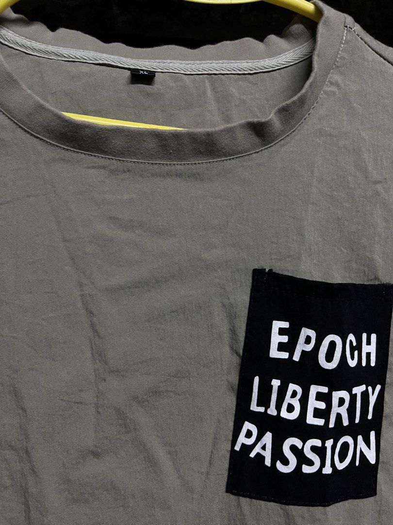 Epoch Liberty Passion T-shirt (Category: Tshirts & Polo Shirts ) located in Taguig. Submitted by misguidedghost (Listing ID 1438469993, Image 2). Description: Brown Printed Shirt with Front Pocket Brand: No Brand Size: XL - Unique design with "Epoch Liberty Passion" on the pocket. - Round neck and short sleeves. - Black accents on sleeves and bottom hem. - Neutral color. - Ideal for casual wear..