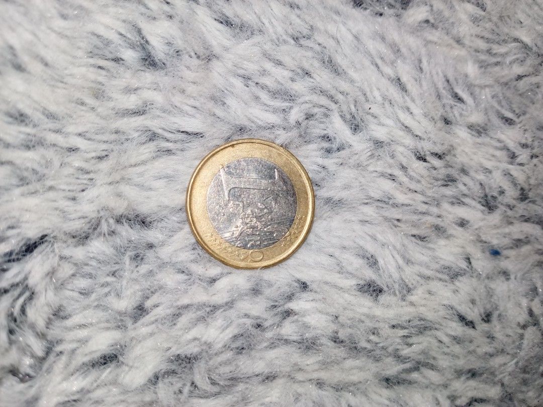 Euro Coin (Category: Currency) located in Manila. Submitted by daz_z (Listing ID 1438338227, Image 1). Description: - Collectible Euro coin - Gold-colored outer ring - Silver-colored center - Features a bridge design on one side - Cross-like pattern on the other side.