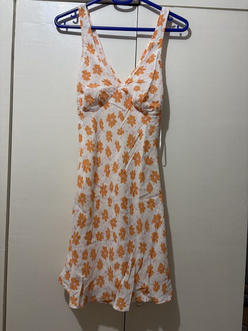 Floral Print Mini Dress (Category: Dresses) located in Pasig City. Submitted by lightningirl (Listing ID 1438494660, Image 2). Description: XXS on tag but fits XS - Floral mini dress - White with orange floral print - V-neckline - Spaghetti straps - Lightweight fabric - Fitted bodice - Slightly flared skirt - Ideal for warm weather.