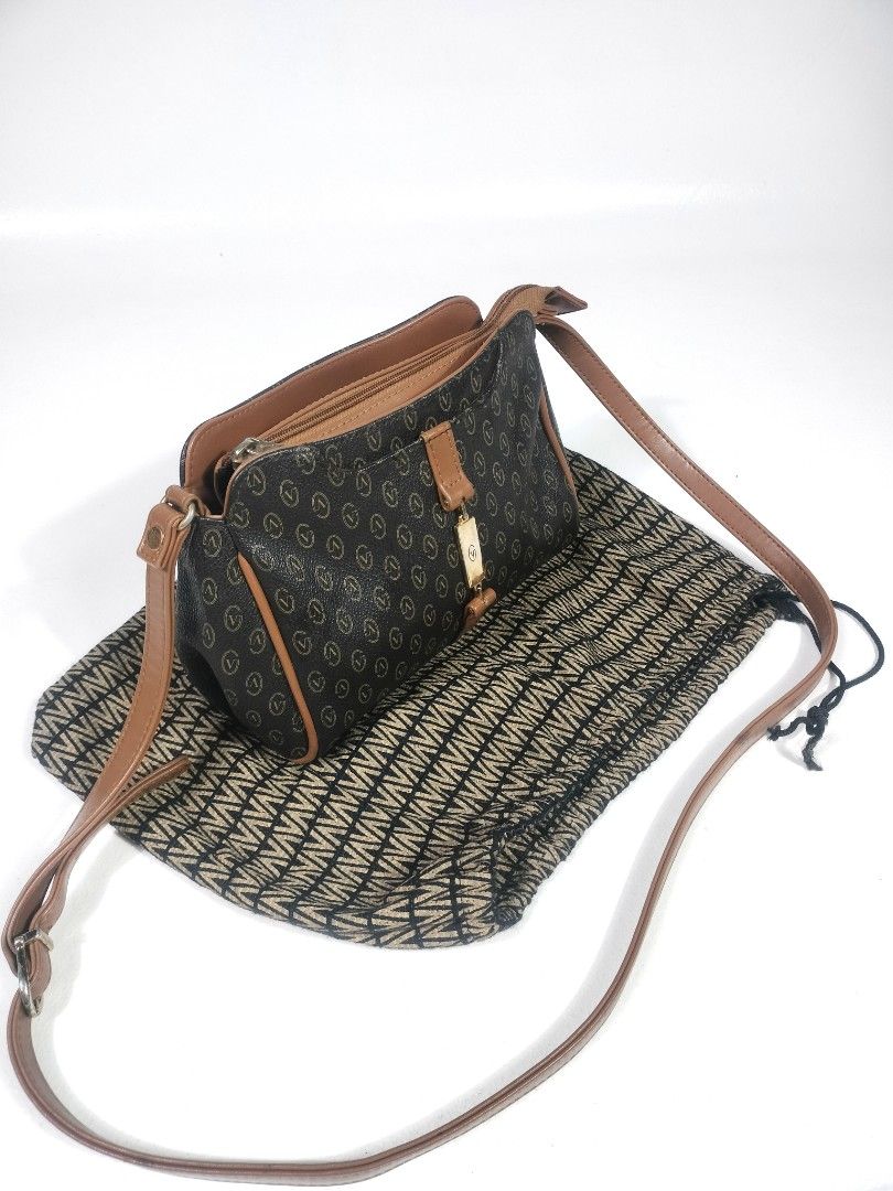 Gianni Valentino Crossbody Bag (Category: Luxury Bags & Wallets) located in Manila. Submitted by callmetin (Listing ID 1438428306, Image 3). Description: - Gianni Valentino crossbody bag - Brown monogram pattern with leather accents - Includes dust bag - Top zipper closure - Adjustable shoulder strap - Lined interior - Gold-tone metal logo detail.