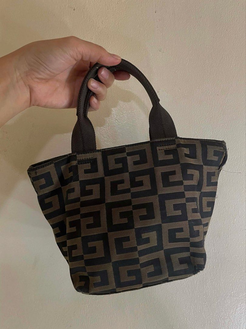 Givenchy Mini Tote (Category: Luxury Bags & Wallets) located in Manila. Submitted by thevintagebow (Listing ID 1438446764, Image 1). Description: Authentic GIVENCHY Brown / Black 4G Mini Tote 👜 Elevate your street style with this vertical mini bag. Iconic 4G logo pattern with premium leather handles and detailing. Price: ₱2,500 php only! Market Comparison: Save over 90% vs. boutique prices! Perfect for collectors. Comment “MINE” or DM for more d