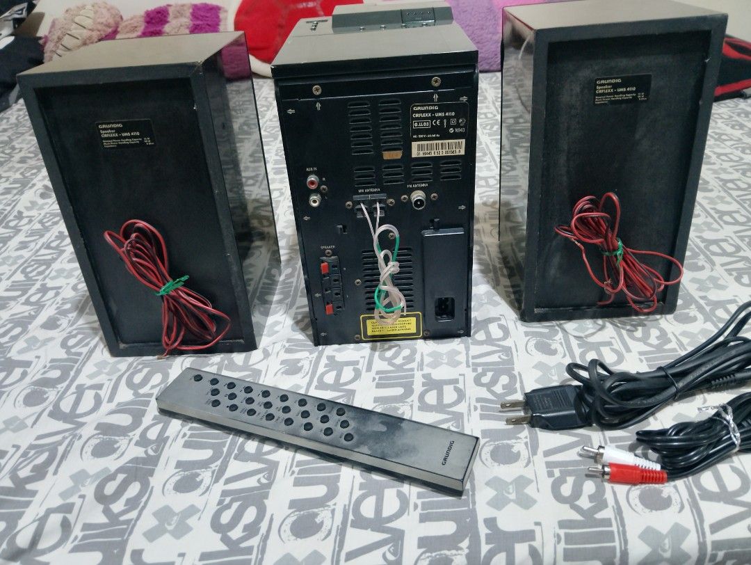 Grundig Cirflexx UMS 4110 Stereo System (Category: Soundbars, Speakers & Amplifiers) located in Manila. Submitted by boyhet.thrift15 (Listing ID 1434247500, Image 3). Description: - Grundig Cirflexx UMS 4110 stereo system - Includes speakers, remote control, and cables - Features: CD player, tuner, and AUX input - Remote control for easy operation - Display shows radio frequency and settings - Back panel with various input/output options - used i