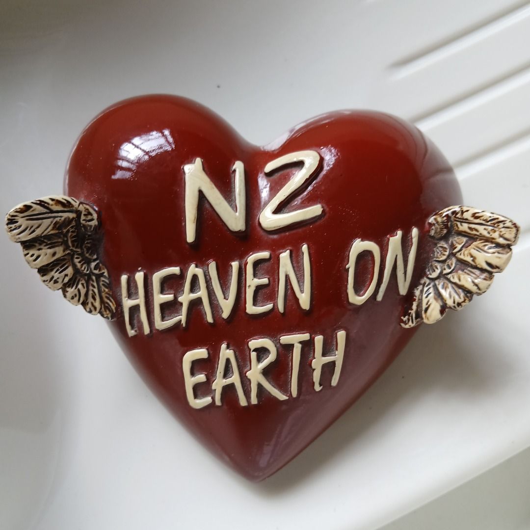Heart-Shaped Ornament with Wings (Category: Other Home Decor) located in Pasig City. Submitted by arlafontam89410 (Listing ID 1438362120, Image 1). Description: Heart-shaped ornament features the words "N2 Heaven on Earth" and small wings on either side. The ornament is a deep red color. There is a hole on the back, suggesting it can be hung. It is a unique decorative piece..