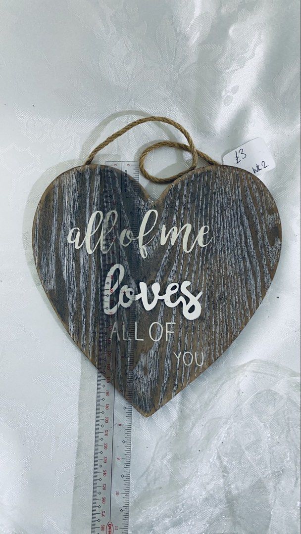 Heart-Shaped Wooden Wall Decor (Category: Wall Decor) located in Quezon City. Submitted by smithram (Listing ID 1438325154, Image 3). Description: - Heart-shaped wooden wall decor - Features the quote "all of me loves all of you" - Rustic, distressed finish - Includes jute rope for easy hanging - Approximately 10 inches in height - Comes with care instructions sticker.