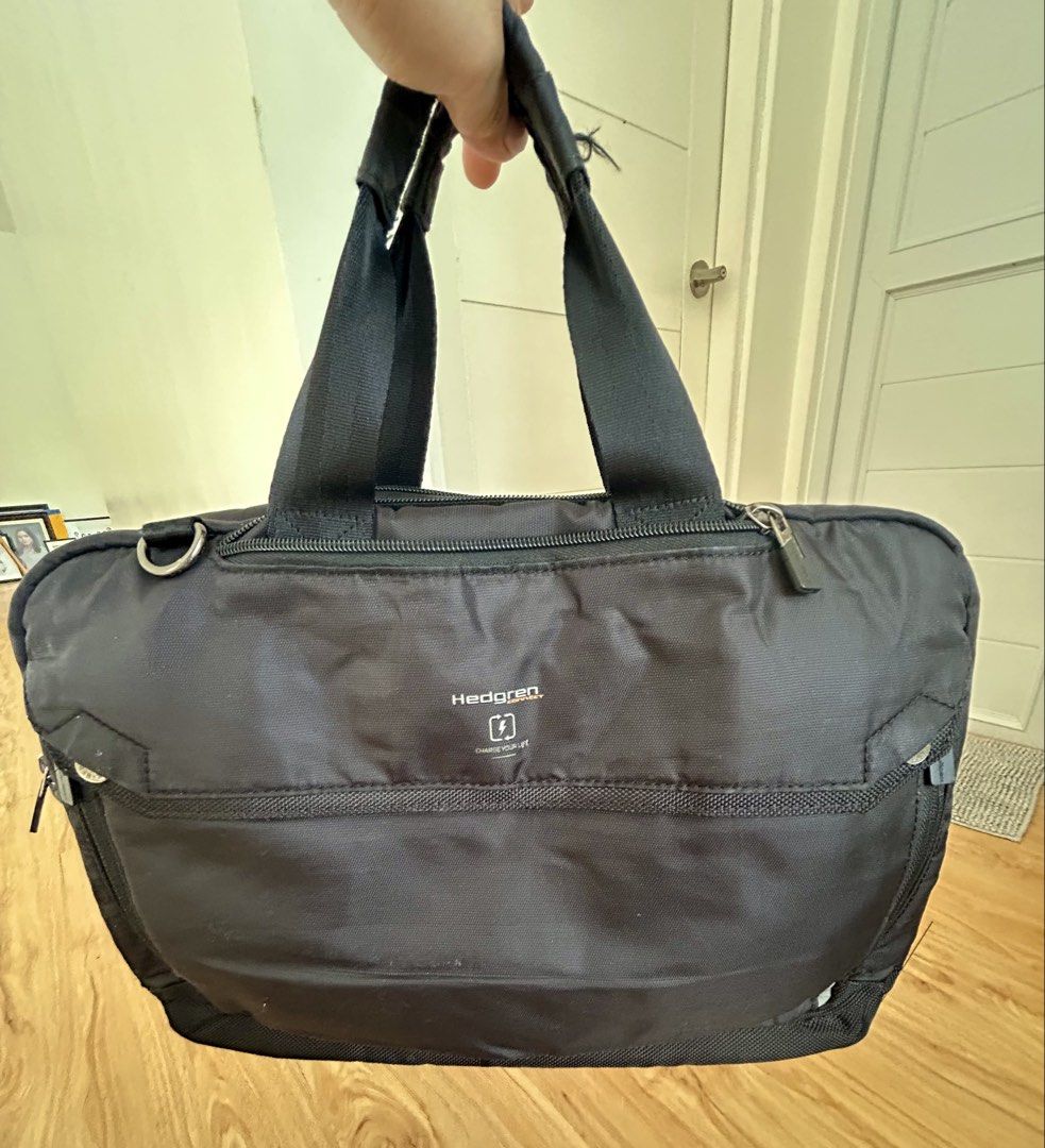 Hedgren Black Handbag (Category: Briefcases) located in Las Pinas. Submitted by cheese_y (Listing ID 1438334089, Image 2). Description: - Black Hedgren handbag - Top handles - Convertible to backpack - Multiple zippered compartments for organization - Front pocket for easy access - Silver-toned zipper - Small Hedgren logo tag - Made from durable, water-resistant fabric - Ideal for everyday use.
