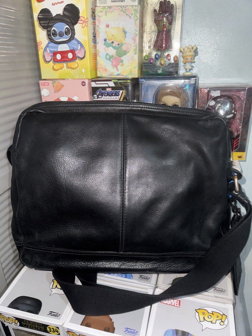 Hugo Boss Black Leather Messenger Bag (Category: Luxury Bags & Wallets) located in Pasay City. Submitted by vinsanity41546 (Listing ID 1438489436, Image 3). Description: - Hugo Boss messenger bag - Black leather - Front zippered pocket - Main compartment with interior pockets - Detachable shoulder strap - Leather logo tag - Zippered closure - Lined interior.