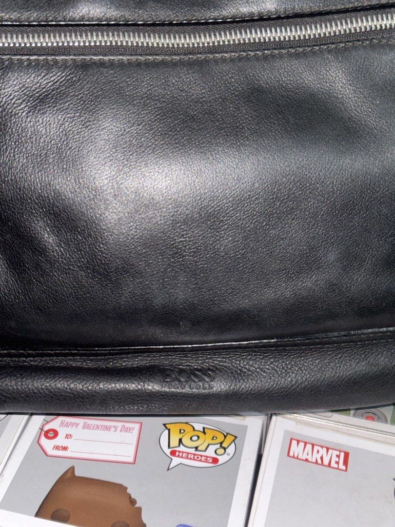 Hugo Boss Black Leather Messenger Bag (Category: Luxury Bags & Wallets) located in Pasay City. Submitted by vinsanity41546 (Listing ID 1438489436, Image 2). Description: - Hugo Boss messenger bag - Black leather - Front zippered pocket - Main compartment with interior pockets - Detachable shoulder strap - Leather logo tag - Zippered closure - Lined interior.