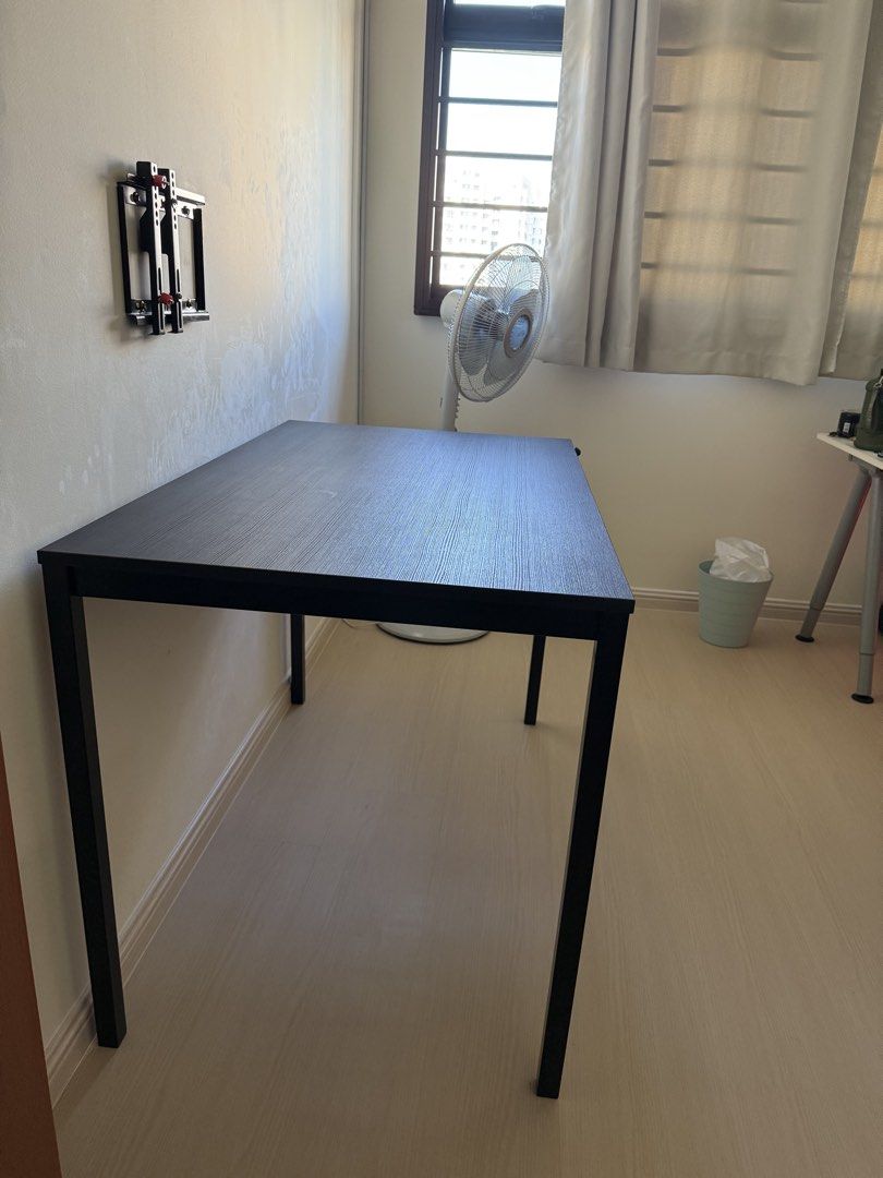 Ikea Black Rectangular Table (Category: Tables & Sets) located in Singapore. Submitted by XxXxHANxXxX (Listing ID 1438347154, Image 2). Description: - Black rectangular table with metal square leg, more stable - Suitable as desk or dining table - Clean, minimalist design - Ready for immediate use. Can arrange for self collection (791470).
