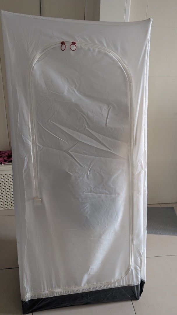 IKEA VUKU Portable Wardrobe (Category: Shelves, Cabinets & Racks) located in Manila. Submitted by decluttering_9917354 (Listing ID 1438363855, Image 2). Description: - IKEA VUKU portable wardrobe - White fabric cover with zippered front - Metal frame - Includes hanging rod for clothes - Base for storage - Lightweight and easy to assemble - Perfect for temporary storage or small spaces - dimensions: 74 x 51 x 149 cm - Clothes NOT INCLUDED..