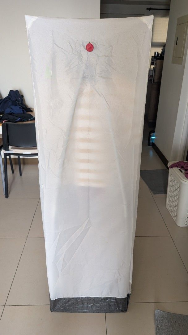 IKEA VUKU Portable Wardrobe (Category: Shelves, Cabinets & Racks) located in Manila. Submitted by decluttering_9917354 (Listing ID 1438363855, Image 3). Description: - IKEA VUKU portable wardrobe - White fabric cover with zippered front - Metal frame - Includes hanging rod for clothes - Base for storage - Lightweight and easy to assemble - Perfect for temporary storage or small spaces - dimensions: 74 x 51 x 149 cm - Clothes NOT INCLUDED..