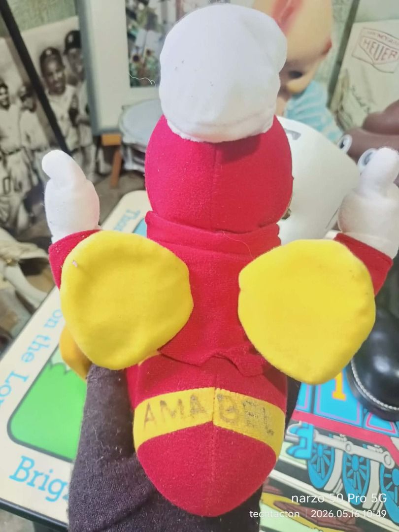 Jollibee Plush Toy (Category: Plushies & Soft Toys) located in Santo Tomas. Submitted by pickers_corner (Listing ID 1438381606, Image 3). Description: vintage 90s Jollibee Doll Rare Vinyl Plushie h26cm standing position needs cleaning as is Jollibee plush toy features the iconic mascot in its classic outfit. It has a red jacket, yellow legs, and a white chef's hat. The tag indicates it was made in China exclusively for Jollibee Foods Corporation.