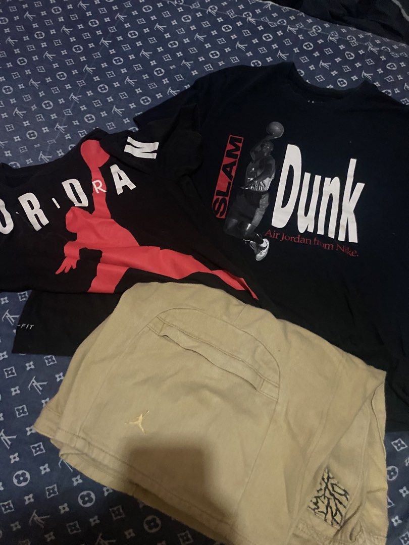 Jordan T-shirts and Shorts Set (Category: Tshirts & Polo Shirts ) located in Davao. Submitted by jaydenpar40213 (Listing ID 1438355114, Image 1). Description: - Includes: Black Jordan t-shirt (red logo), Navy 'Slam Dunk' t-shirt, Khaki Jordan shorts. - Stylish and comfortable outfit. - Perfect for everyday wear..
