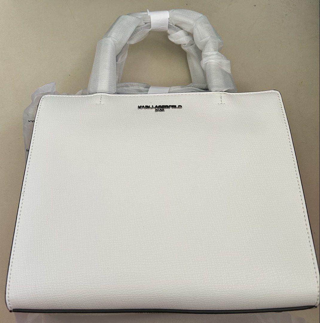 Karl Lagerfeld Winter White Book Tote with Strap (Category: Luxury Bags & Wallets) located in Pasig City. Submitted by jrrhs (Listing ID 1438389401, Image 1). Description: - Karl Lagerfeld handbag - Color: Winter White - Top handle design - Secure zipper closure - Interior with Karl Lagerfeld label - Style Code: LH1DRBBJ - Color Code: 0WW - Comparable Value: $198.00.
