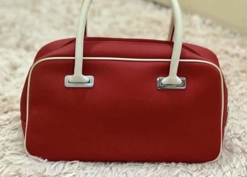 Lacoste Red Bowling Bag with White Handles (Category: Tote Bags) located in Muntinlupa City. Submitted by hollieberrygirl (Listing ID 1438312077, Image 2). Description: Red & White Lacoste🐊 Bowling Bag - small Store bought With minor stains inside the bag from storage. ₱4,650 SF c/o buyer NO RETURN NO EXCHANGE.