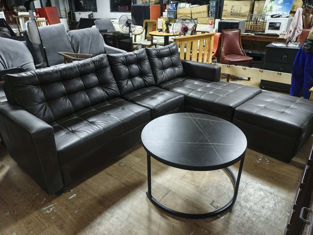 Leather Sectional Sofa with Ottoman and Coffee Table (Category: Sofas) located in Manila. Submitted by marquezpa52205 (Listing ID 1438472142, Image 1). Description: - Sectional sofa with matching ottoman and coffee table - Dark brown leather upholstery - Features tufted detailing - Ottoman provides extra seating or footrest - Round coffee table with unique black top design - Black metal frame - Ideal for living room setup.