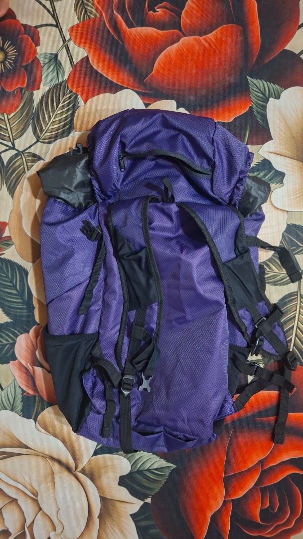 Lightweight Backpack (Category: Backpacks) located in Melaka Tengah. Submitted by cleptomaniac (Listing ID 1438493713, Image 2). Description: - Bosabao Thilum Series backpack - Color: Purple and Black - Multiple compartments for organization - Adjustable straps - Foldable design for easy storage - Comes with a storage bag.
