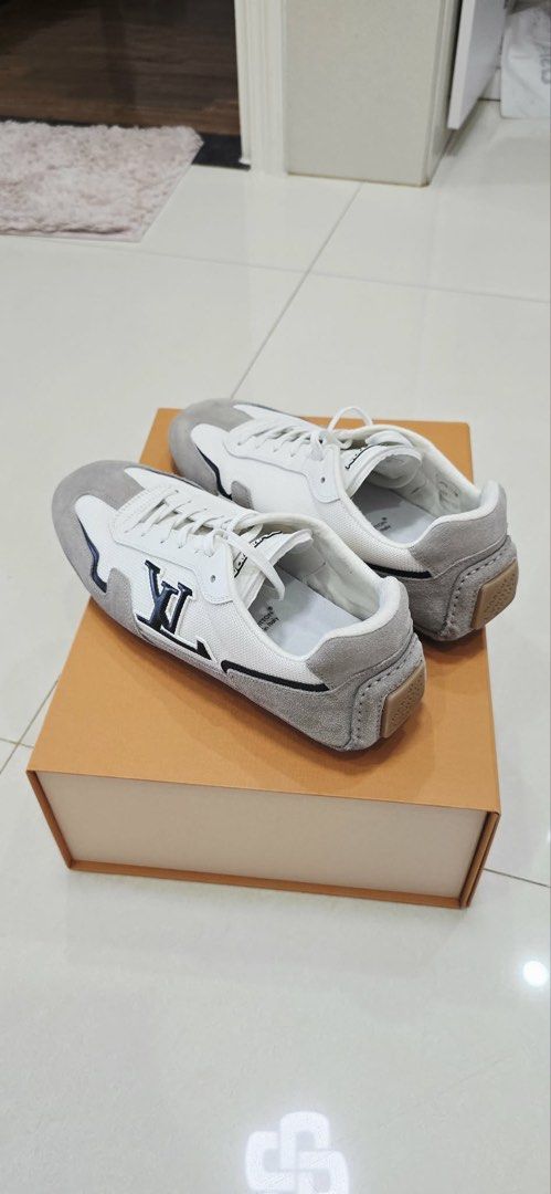 Louis Vuitton LV Trainer Sneakers (Category: Sneakers) located in Manila. Submitted by act23 (Listing ID 1438375917, Image 1). Description: - Authentic Louis Vuitton LV Trainer sneakers - Color: White and Grey - Features the iconic LV logo - Made in Italy - Comes with the original box - Classic low-top design - Lace-up closure.
