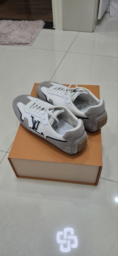 Louis Vuitton LV Trainer Sneakers (Category: Sneakers) located in Manila. Submitted by act23 (Listing ID 1438375917, Image 2). Description: - Authentic Louis Vuitton LV Trainer sneakers - Color: White and Grey - Features the iconic LV logo - Made in Italy - Comes with the original box - Classic low-top design - Lace-up closure.