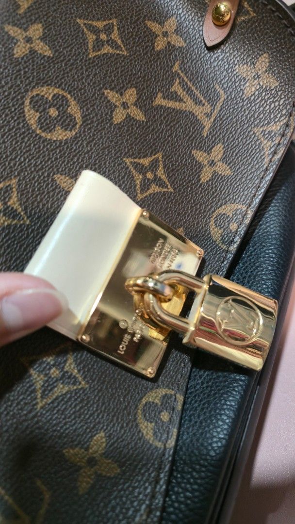 Louis Vuitton Monogram Handbag (Category: Luxury Bags & Wallets) located in Caloocan City. Submitted by sandy119 (Listing ID 1438326659, Image 2). Description: - Authentic Louis Vuitton handbag - Iconic monogram pattern - Top handle design - Secure lock closure - Gold-tone hardware - Black interior - Structured shape - Black leather base.