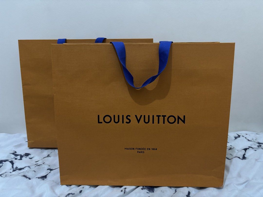 Louis Vuitton Paper Bag (Category: Luxury Bags & Wallets) located in Pateros City. Submitted by sanchezgerard11 (Listing ID 1438478892, Image 1). Description: - Authentic Louis Vuitton paper bag - Features the iconic Louis Vuitton logo and "Maison Fondée en 1854 Paris" text - Blue handles - Light-colored interior - Includes recycling information - Size: Large - Qty: 2 pieces available .