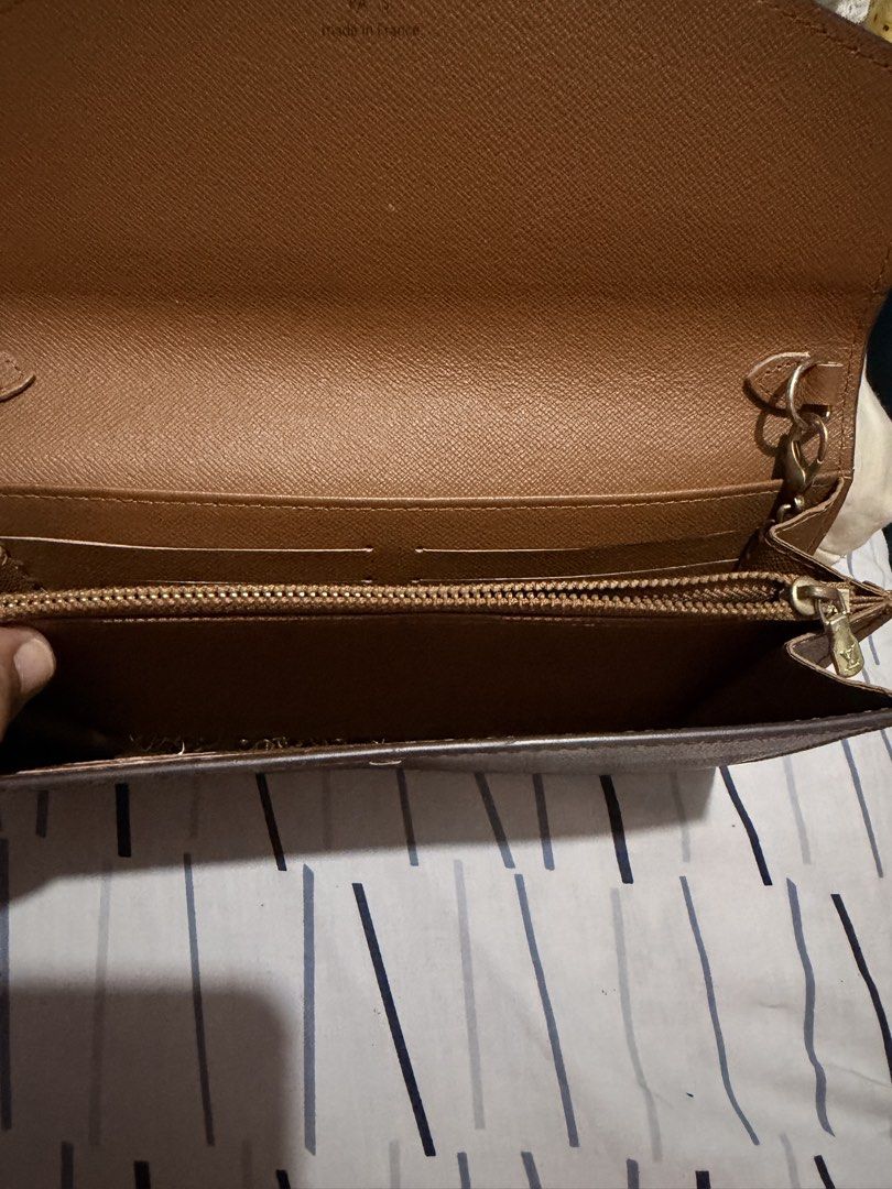 Louis Vuitton Wallet and Black Clutch (Category: Luxury Bags & Wallets) located in Taguig. Submitted by marshmy (Listing ID 1438352997, Image 2). Description: - Authentic Louis Vuitton wallet with monogram pattern - Snap closure - Multiple compartments - Black clutch with gold-tone clasp and chain strap - Red interior.