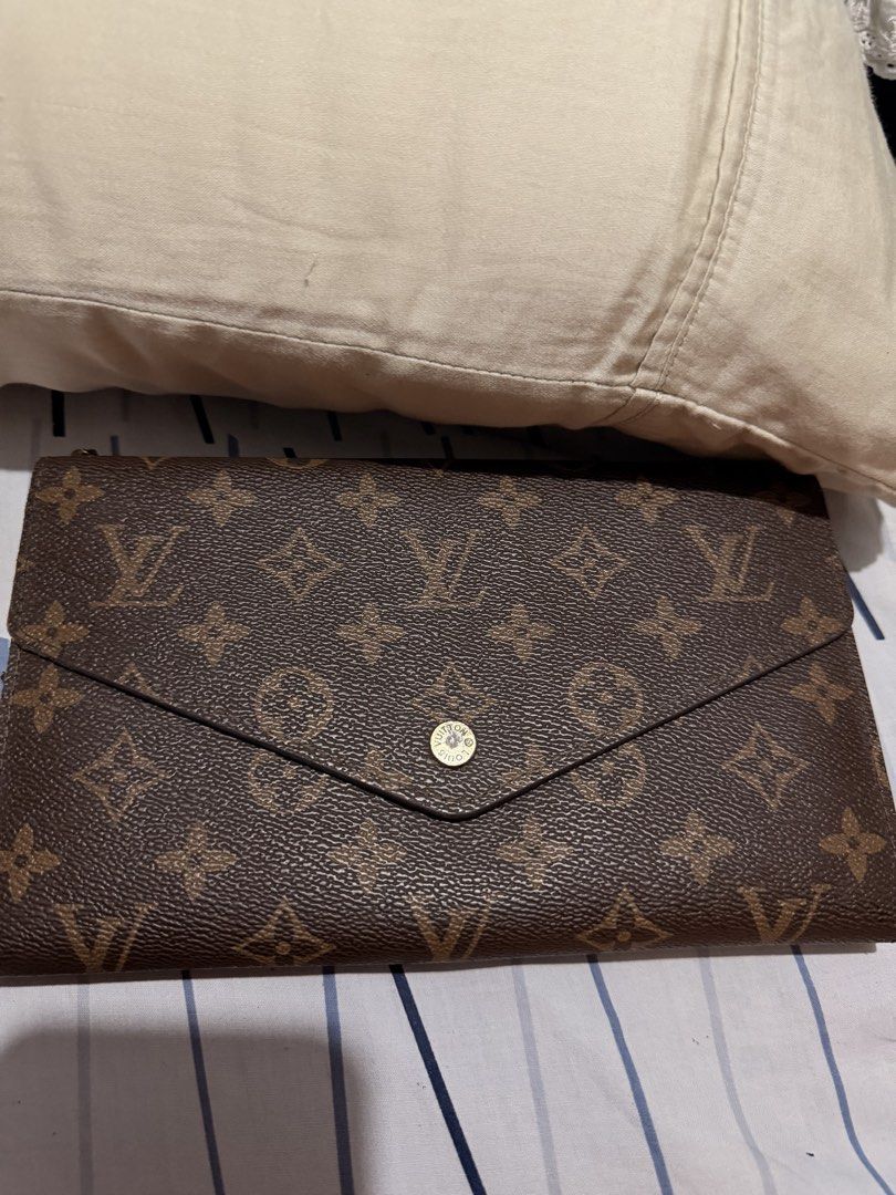 Louis Vuitton Wallet and Black Clutch (Category: Luxury Bags & Wallets) located in Taguig. Submitted by marshmy (Listing ID 1438352997, Image 1). Description: - Authentic Louis Vuitton wallet with monogram pattern - Snap closure - Multiple compartments - Black clutch with gold-tone clasp and chain strap - Red interior.