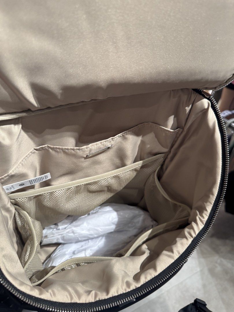 Lululemon New Parent Backpack (Category: Backpacks) located in Bacoor. Submitted by karlarmrz (Listing ID 1438318498, Image 3). Description: - Lululemon New Parent Backpack - Color: Black - Large main compartment - Multiple interior pockets - Includes separate pouch - Includes changing mat - Front zippered pocket - Top handle - Light beige interior lining - Smooth, black exterior material BRAND NEW FROM KOREA EDA MAY 20 Ships from Bacoor or Pasay