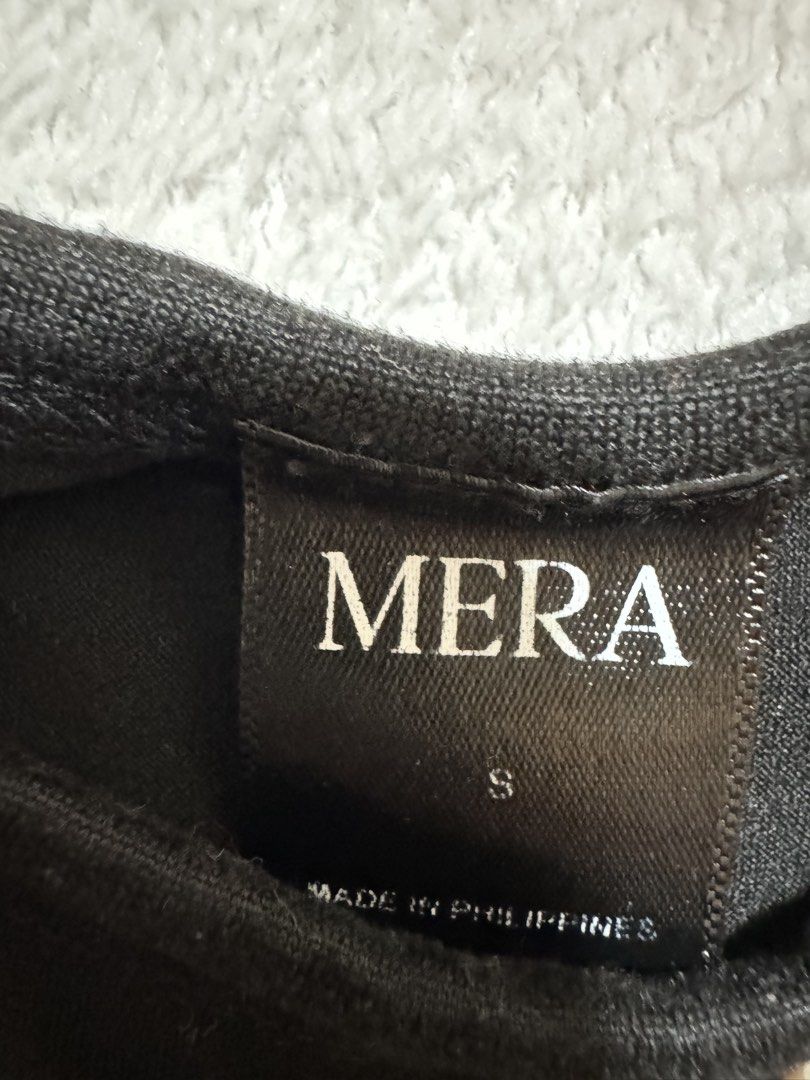 Mera Black T-shirt - Size S (Category: Shirts) located in Mandaluyong City. Submitted by toront0427 (Listing ID 1438472988, Image 3). Description: - Black Mera t-shirt - Size: S - Style: Fitted - Neckline: Crew neck - Sleeves: Short sleeves - Material: Likely a cotton blend - Made in the Philippines.