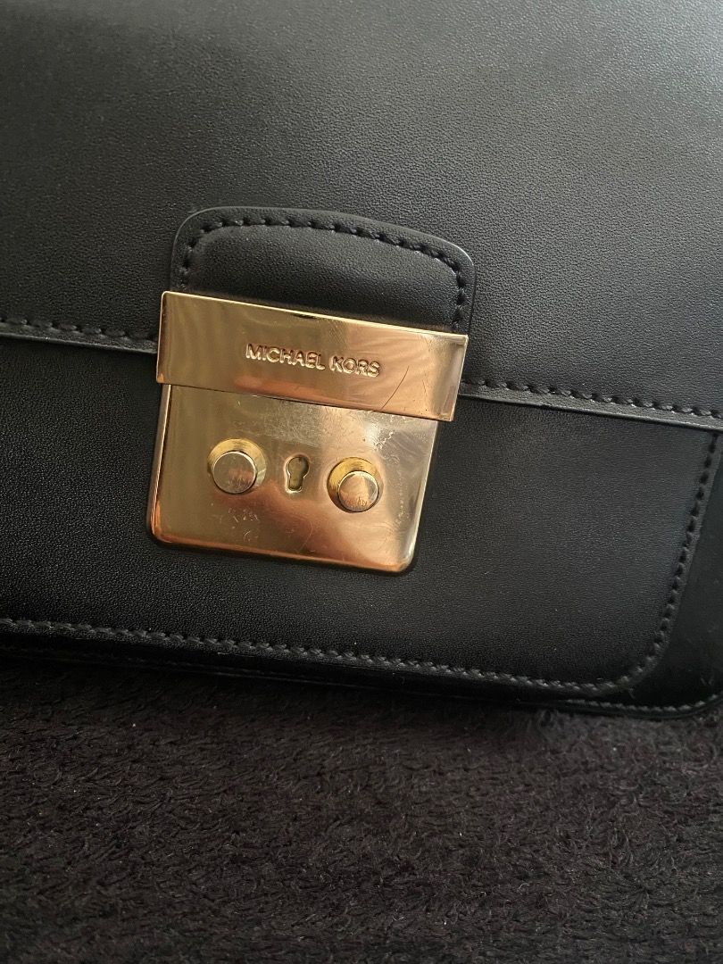Michael Kors Black Crossbody Bag (Category: Luxury Bags & Wallets) located in Paete. Submitted by ladder_leynn (Listing ID 1438322548, Image 2). Description: - Black Michael Kors crossbody bag - Gold-tone hardware - Flap closure with logo detail - Adjustable shoulder strap - Interior zippered pocket - Made of leather - Back pocket -authenticity not guaranteed negotiable price.