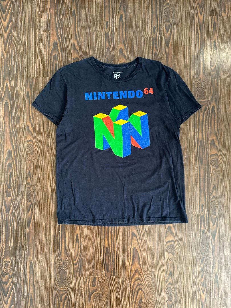 Nintendo 64 Logo Graphic Shirt (Category: Tshirts & Polo Shirts ) located in Santa Rosa. Submitted by younoanco (Listing ID 1438474008, Image 1). Description: Nintendo 64 Logo Graphic Shirt Size: Large Pit to Pit: 21 inches Length: 27.5 inches With minor crack prints.