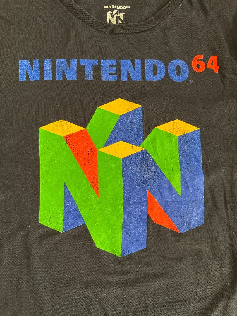 Nintendo 64 Logo Graphic Shirt (Category: Tshirts & Polo Shirts ) located in Santa Rosa. Submitted by younoanco (Listing ID 1438474008, Image 2). Description: Nintendo 64 Logo Graphic Shirt Size: Large Pit to Pit: 21 inches Length: 27.5 inches With minor crack prints.