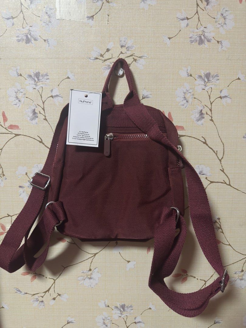NuPrene - The Raya Mini Backpack - Water-Resistant Backpack in Wine (Category: Backpacks) located in Manila. Submitted by AAA09876 (Listing ID 1438410889, Image 2). Description: - NuPrene mini backpack - Maroon color - Two front zippered pockets - Top handle - Adjustable straps - Includes tag - Stylish and compact design.