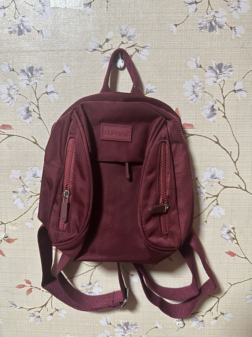 NuPrene - The Raya Mini Backpack - Water-Resistant Backpack in Wine (Category: Backpacks) located in Manila. Submitted by AAA09876 (Listing ID 1438410889, Image 1). Description: - NuPrene mini backpack - Maroon color - Two front zippered pockets - Top handle - Adjustable straps - Includes tag - Stylish and compact design.