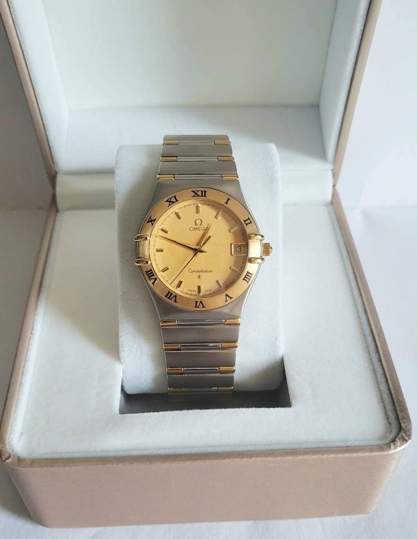 Omega Constellation Gold Watch (Category: Luxury Watches) located in Manila. Submitted by junri0 (Listing ID 1438396850, Image 2). Description: - Omega Constellation watch - Gold dial with Roman numeral hour markers - Date display at 3 o'clock -35.5mm case size -Ref # 1312.10 -Fit up to 17.5cm wrist - Two-tone stainless steel and gold bracelet - Comes with provided box only - Perfect for everyday wear or special occasions.