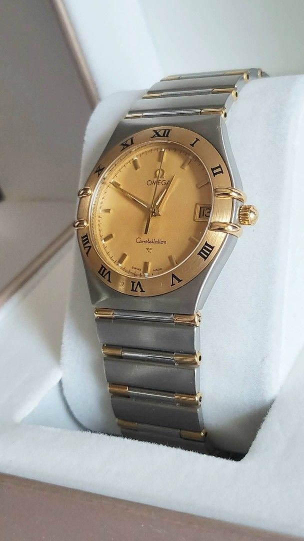 Omega Constellation Gold Watch (Category: Luxury Watches) located in Manila. Submitted by junri0 (Listing ID 1438396850, Image 3). Description: - Omega Constellation watch - Gold dial with Roman numeral hour markers - Date display at 3 o'clock -35.5mm case size -Ref # 1312.10 -Fit up to 17.5cm wrist - Two-tone stainless steel and gold bracelet - Comes with provided box only - Perfect for everyday wear or special occasions.