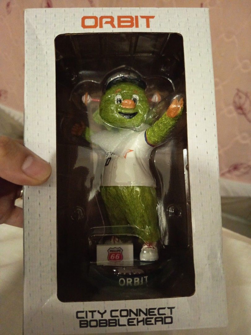 Orbit City Connect Bobblehead Houston Astros baseball (Category: Designer & Blind Box Toys) located in Muntinlupa City. Submitted by toys-22 (Listing ID 1438436614, Image 1). Description: - Orbit City Connect bobblehead - Features a green mascot in a baseball uniform - Includes original packaging - Base design: Route 66 sign - Box has "Orbit" printed on it.