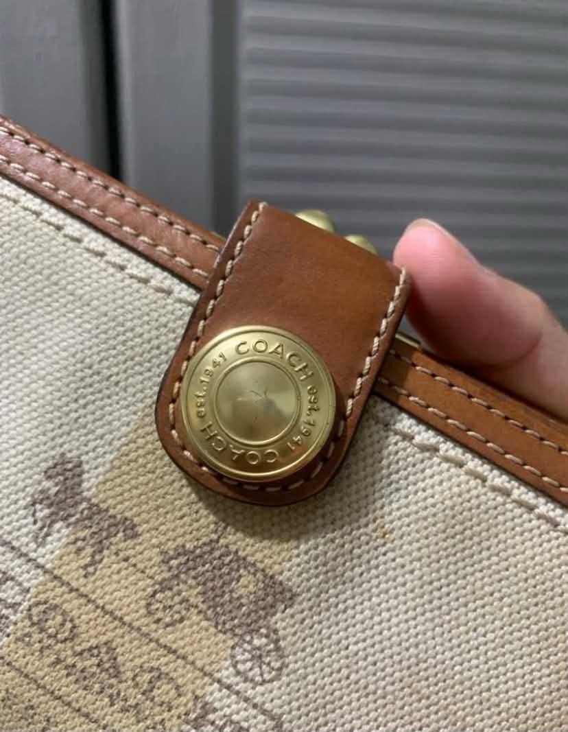 Original Coach Wallet (PAYDAY SALE) (Category: Luxury Bags & Wallets) located in Manila. Submitted by leontheexplorer (Listing ID 1438469061, Image 2). Description: - Original Coach wallet - Canvas exterior with leather trim - Snap closure - Gold-tone Coach logo - Multiple card slots - Coin compartment - Brown and beige color scheme - Classic design - Needs a little cleaning.