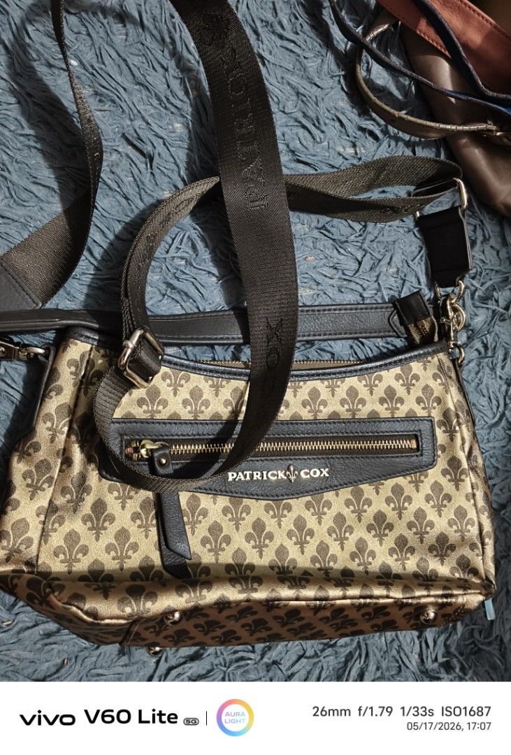 Patrick Cox Crossbody Bag (Category: Luxury Bags & Wallets) located in Pasay City. Submitted by cory0223 (Listing ID 1438409587, Image 1). Description: - Patrick Cox crossbody bag - Unique pattern - Adjustable strap - Zippered front pocket - Interior zippered pocket Guaranteed Original Source Japan.
