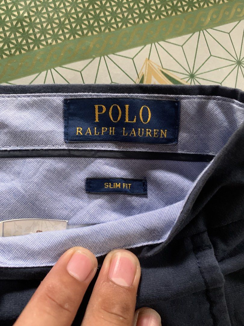 Polo Ralph Lauren Slim Fit Pants (Category: Jeans) located in Manila. Submitted by pole.thirft (Listing ID 1438393604, Image 3). Description: - Navy blue Polo Ralph Lauren slim fit pants - Button closure and zipper - Classic design - Polo logo on back pocket - Material and supplier information on tag - Suitable for various occasions.