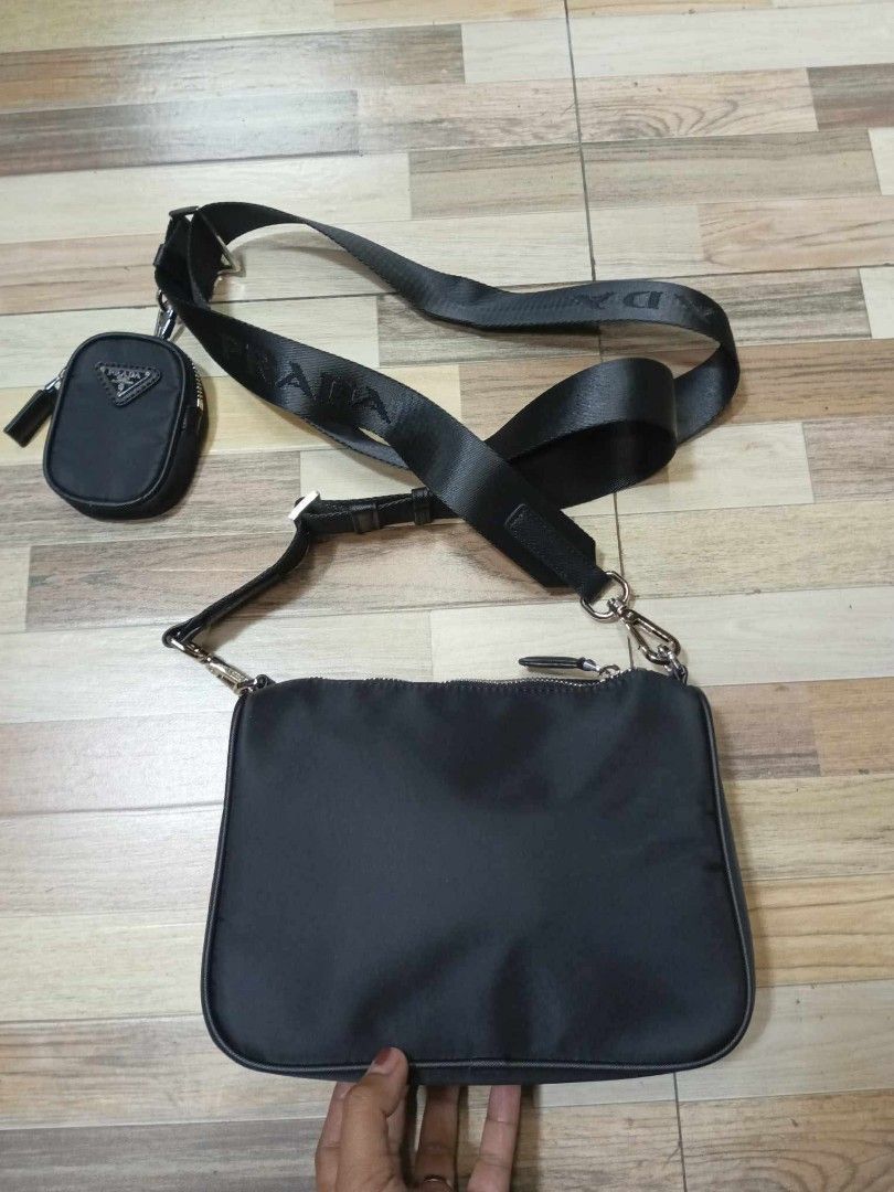 Prada Black Nylon Crossbody Bag with Pouch (Category: Cross-body Bags) located in Baguio. Submitted by brandeditems16 (Listing ID 1438495764, Image 2). Description: - Authentic Prada crossbody bag - Includes a detachable pouch - Adjustable strap with Prada logo - Silver-tone hardware - Main compartment with zipper closure - Durable nylon material.