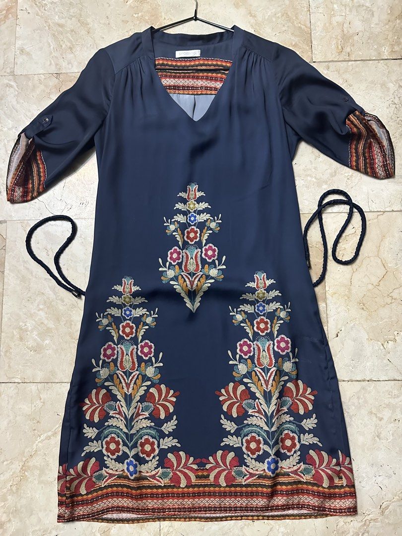 Promod Embroidered Navy Dress (Category: Dresses) located in Malabon City. Submitted by igigs (Listing ID 1438458265, Image 1). Description: - Navy dress - Embroidered floral details - V-neckline with patterned trim - Matching tie belt - Roll-up sleeves with button closure - Straight cut, knee-length - lightly used.