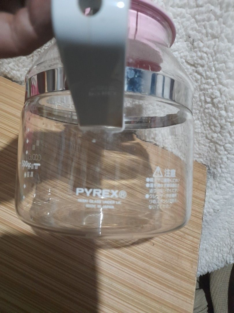 Pyrex Coffee Carafe (Category: Coffee & Tea Tableware) located in Bocaue. Submitted by marajapansurplus (Listing ID 1438420257, Image 2). Description: - Vintage Pyrex coffee carafe - Clear glass body - Pink lid - Gray handle - Silver band detail - Measurement markings - Pyrex logo - Made in Japan.