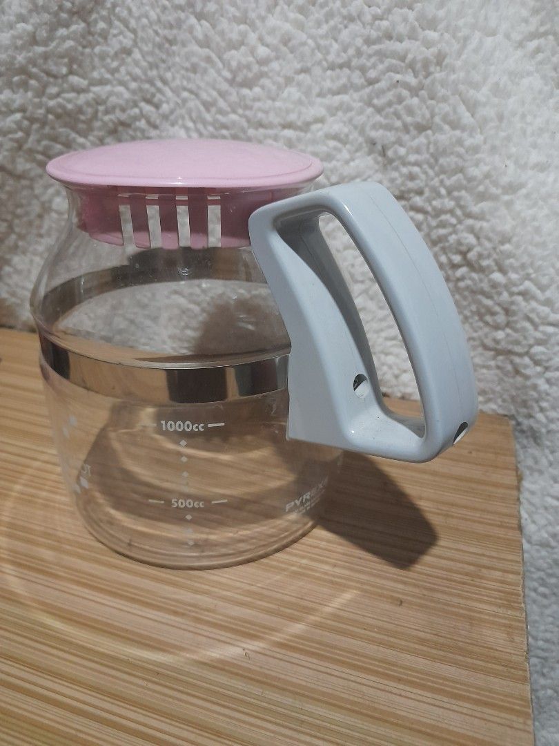 Pyrex Coffee Carafe (Category: Coffee & Tea Tableware) located in Bocaue. Submitted by marajapansurplus (Listing ID 1438420257, Image 3). Description: - Vintage Pyrex coffee carafe - Clear glass body - Pink lid - Gray handle - Silver band detail - Measurement markings - Pyrex logo - Made in Japan.