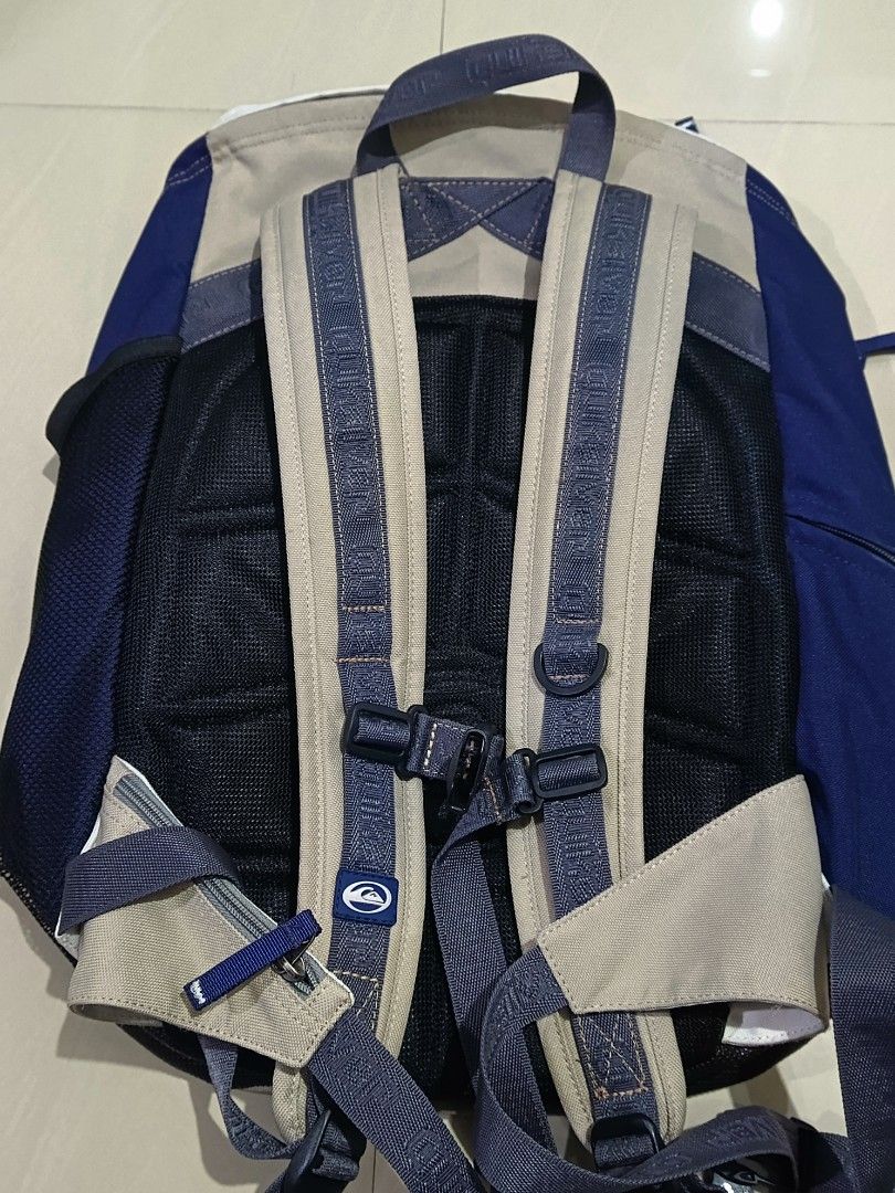 Quiksilver Backpack (Category: Backpacks) located in Davao. Submitted by judelabust72026 (Listing ID 1438428652, Image 3). Description: - Quiksilver backpack - Color: Beige, Blue, White - Padded back panel for comfort - Adjustable shoulder straps - Multiple compartments for storage - Front pocket with Quiksilver logo - Ideal for school, travel, and everyday use.