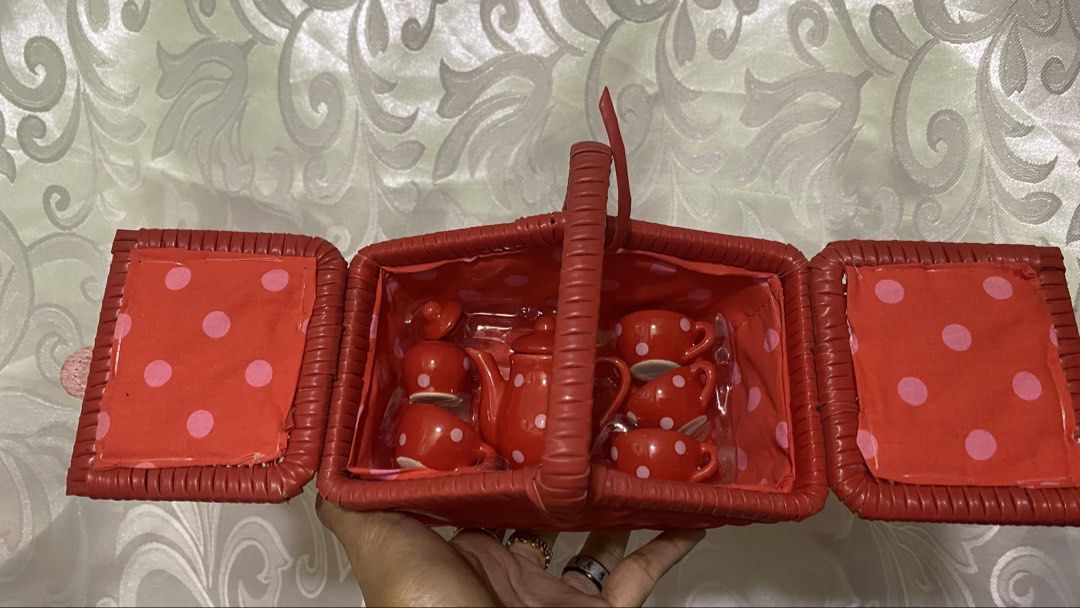 Red Wicker Picnic Basket with Tea Set (Category: Storage Boxes & Baskets) located in Manila. Submitted by 3asonlineshop (Listing ID 1438371146, Image 3). Description: Charming red wicker picnic basket includes a complete tea set. The set features a teapot, cups, saucers, and spoons, all in a matching red color with white polka dots. The basket has a handle and opens to reveal the tea set inside. The interior is lined with red fabric with pink pol